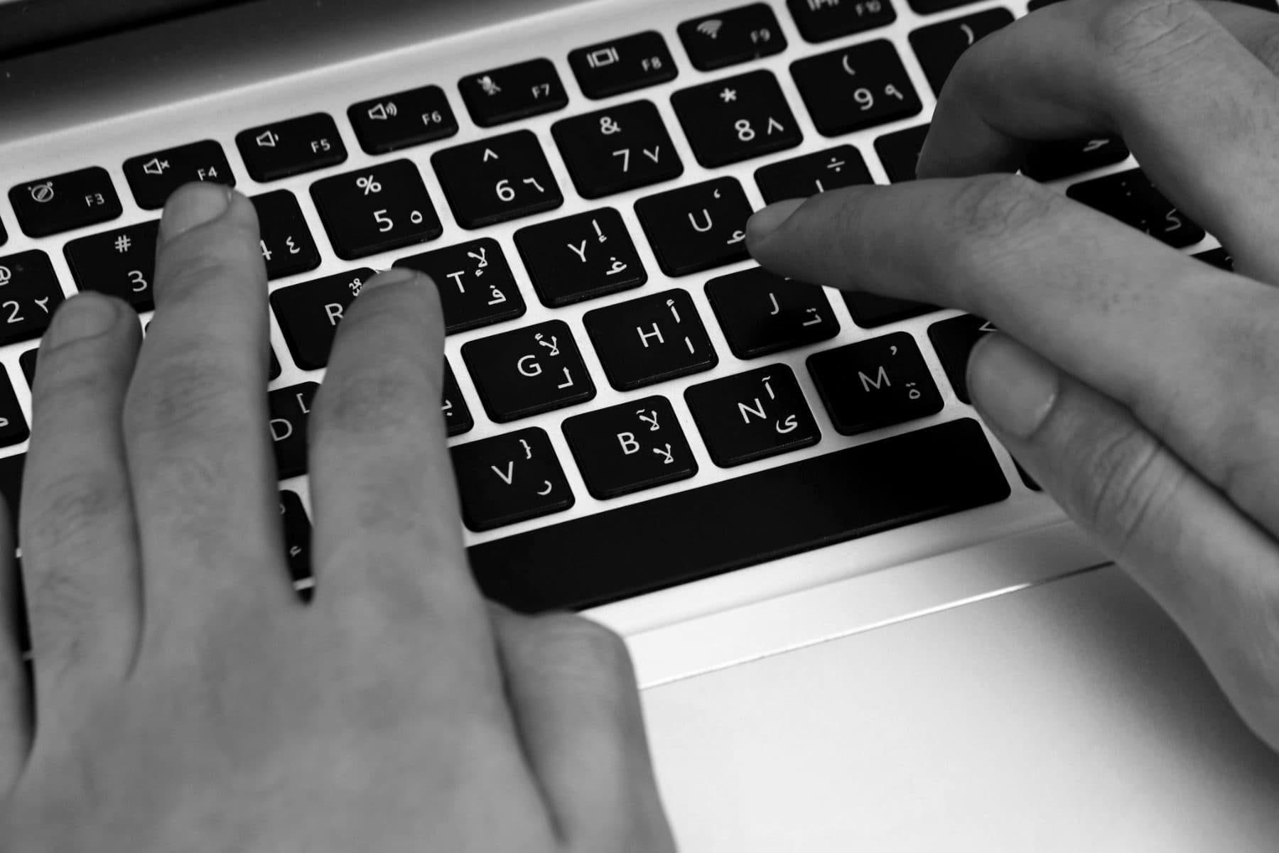 Typing at a laptop keyboard