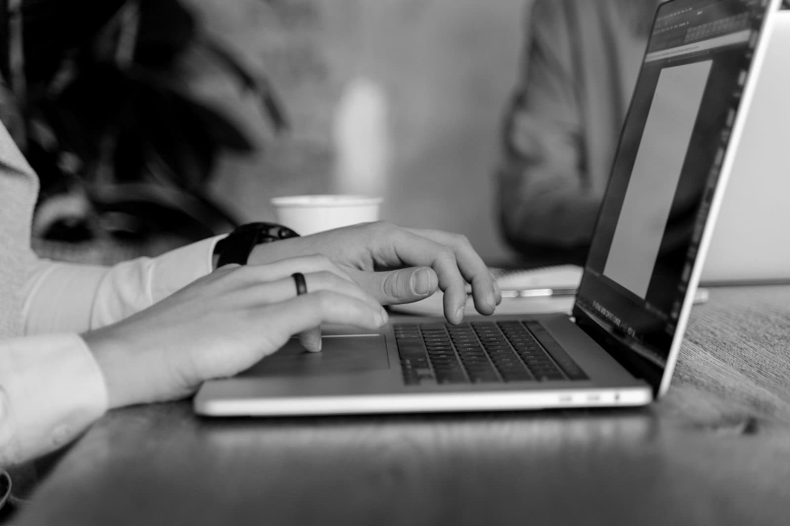 Reviewing customer data on a laptop
